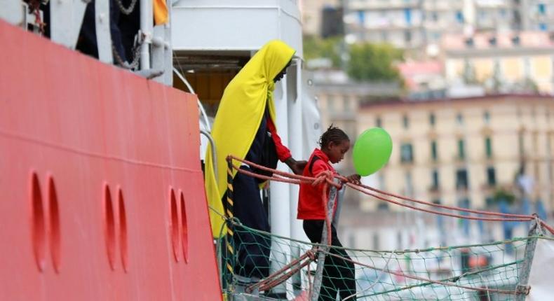 A girl disembarks from the Aquarius rescue ship run by NGO S.O.S. Mediterranee and Medecins Sans Frontieres in the Italian port of Salerno on May 26 2017 after a rescue operation in the Mediterranean