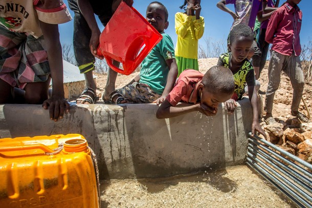 Children drink water delivered by a truck in the drought-stricken Baligubadle village