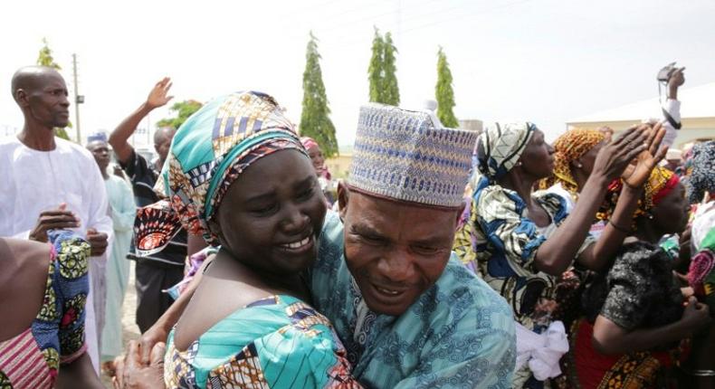 This handout picture released on May 20, 2017 by PGDBA & HND Mass Communication shows family members crying while being reunited with the released Chibok girls in Abuja on May 20, 2017