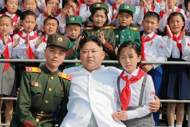 Schoolchildren stand beside North Korean leader Kim Jong Un as he arrives to attend We Are the Happ