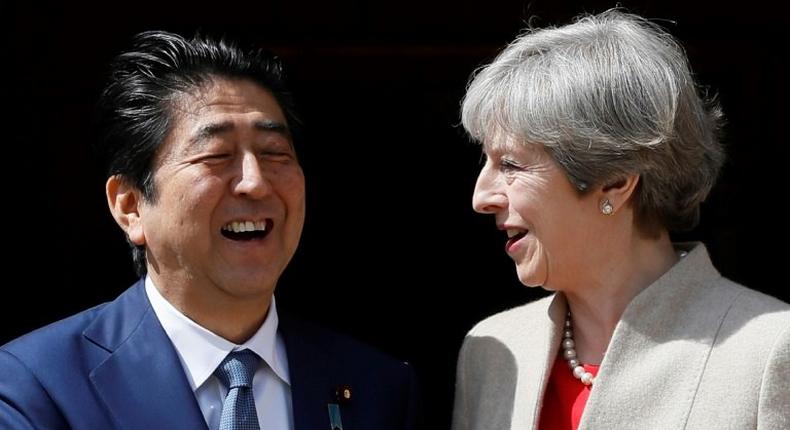 Britain's Prime Minister Theresa May (R) welcomes Japan's Prime Minister Shinzo Abe (L) at Chequers, the prime minister's official country residence, near Ellesborough, northwest of London, on April 28, 2017