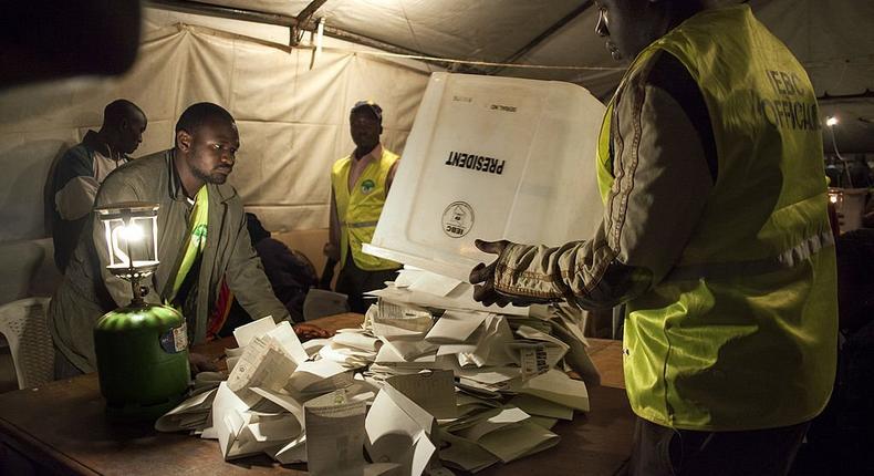 Staff from the Independent Electoral and Boundaries Commission (IEBC) empty ballots for counting at a polling station at the Kibra Social Grounds in Nairobi on March 4, 2013 during the elections. (Photo by Georgina Goodwin/AFP via Getty Images)