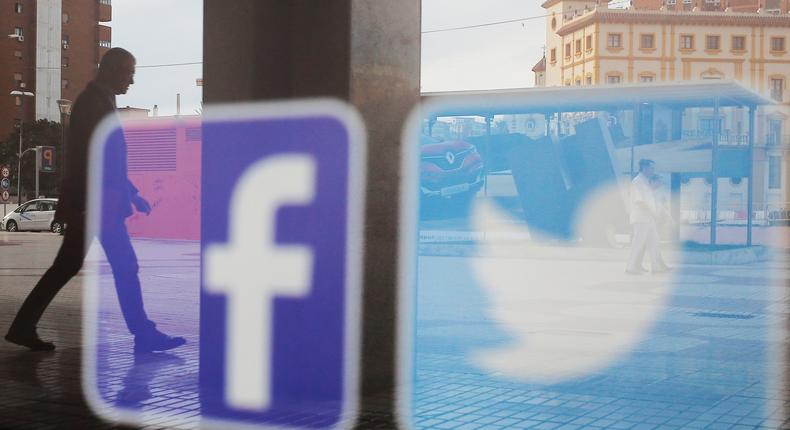 FILE PHOTO: Facebook and Twitter logos are seen on a shop window in Malaga, Spain, June 4, 2018. REUTERS/Jon Nazca