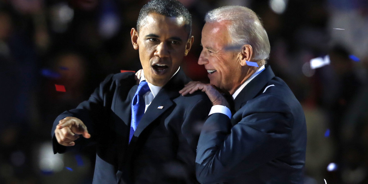 US President Barack Obama gestures with Vice President Joe Biden after his election night victory speech in Chicago, November 6, 2012.