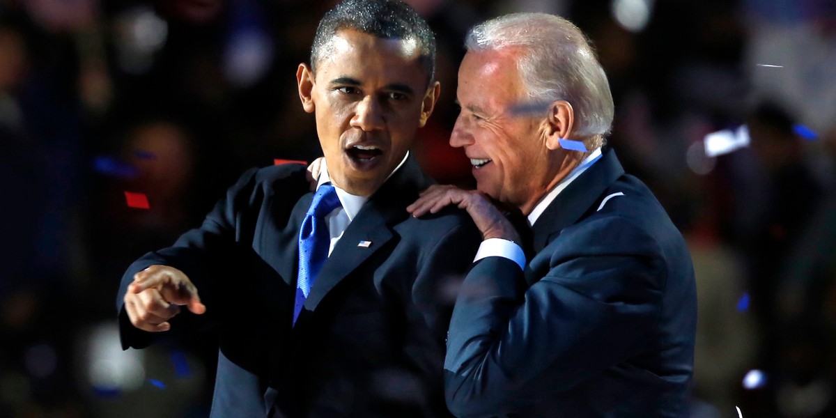 US President Barack Obama gestures with Vice President Joe Biden after his election night victory speech in Chicago, November 6, 2012.