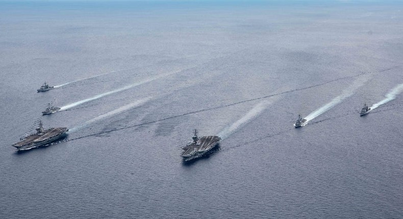 The USS Ronald Reagan (CVN 76) and USS Nimitz (CVN 68) Carrier Strike Groups (CSGs) steam in formation.