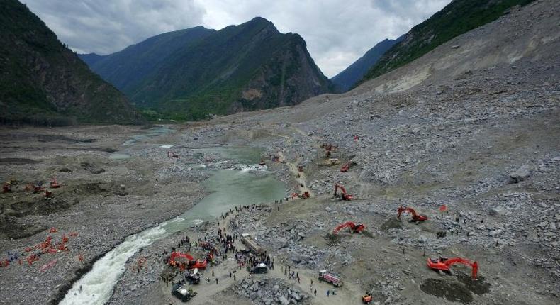 Chinese rescuers search for survivors at a landslide area in the village of Xinmo in Maoxian county, China's Sichuan province