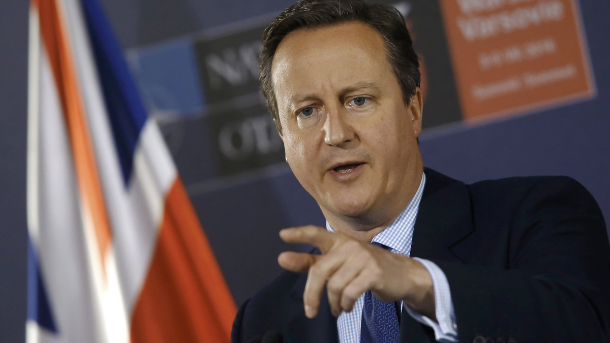 British PM Cameron speaks during a news conference at the PGE National Stadium, the venue of NATO summit, in Warsaw