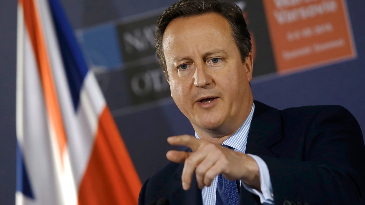 British PM Cameron speaks during a news conference at the PGE National Stadium, the venue of NATO summit, in Warsaw