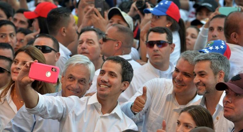 Venezuela's opposition leader Juan Guaido (center) takes a selfie with Chilean President Sebastian Pinera (left), Colombian President Ivan Duque (second right) and Paraguayan President Mario Abdo Benitez (right)