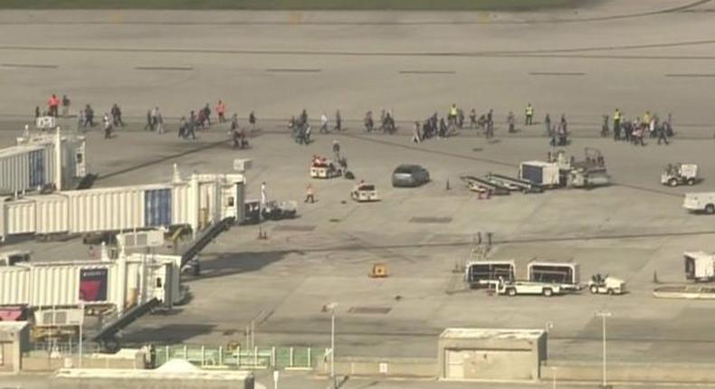 Hundreds of people have been forced to wait on the airport tarmac for police to clear the terminal