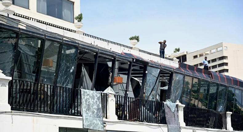 Two men inspect damage from the roof of a restaurant at the Kingsbury Hotel in Colombo on April 22, 2019, a day after it was hit during a series of bomb blasts targeting churches and luxury hotels in Sri Lanka