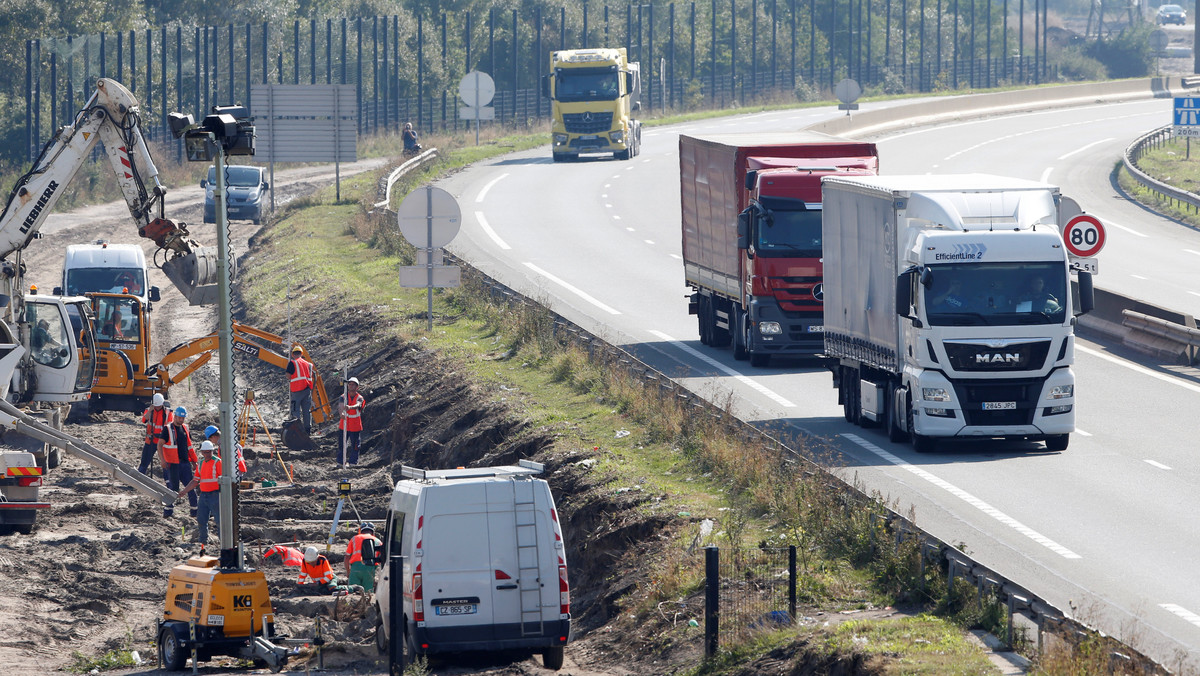 Heavy machinery and construction workers are seen along a motorway stretch in Calais as work gets underway to build a wall to secure the approach to the city from migrants trying to reach Britain, Calais,