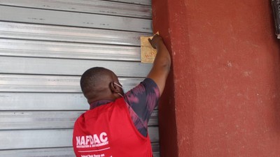 An illustrative photo of a NAFDAC official sealing off a shop. [NAN]