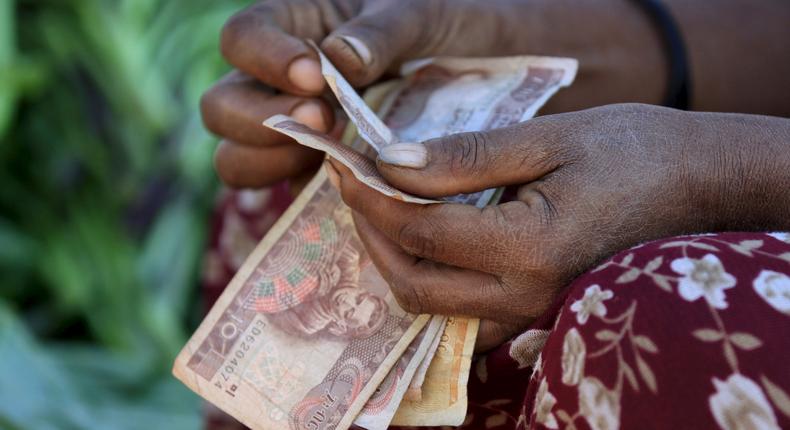 A woman counts Ethiopian birr notes, after selling a cabbage at the Mercato market in Addis Ababa November 14, 2015.( REUTERS/Tiksa Negeri)