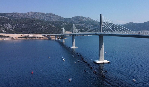 Brijesta, Croatia, July 26, 2022. Aerial view of the traditional race of Neretva Boats under Peljeski Bridge has been held as part of the bridge opening program in Brijesta, Croatia on July 26, 2022. 2.404 meters long bridge is constructed in 4 years by C