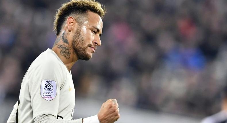 Paris Saint-Germain's Neymar celebrates scoring his 11th league goal of the season against Bordeaux before leaving the field through injury