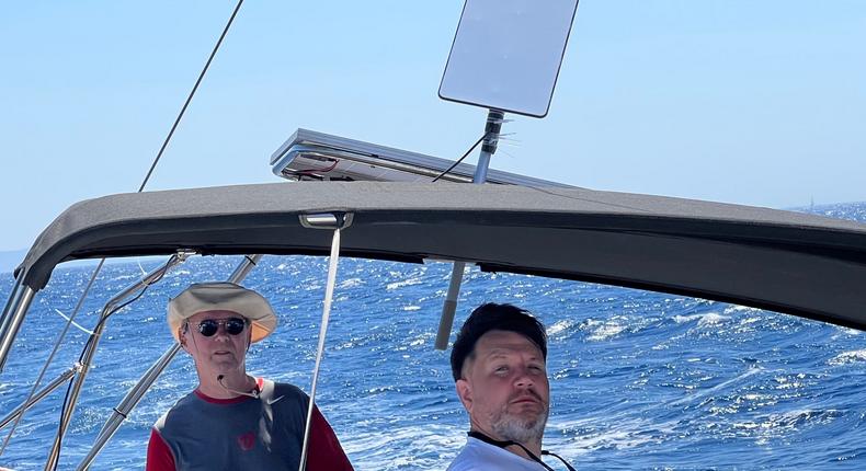 RebelRoam staff on a yacht with a Starlink dish strapped on.