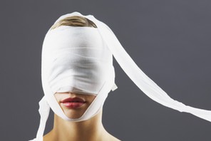 Bandage covering woman's face