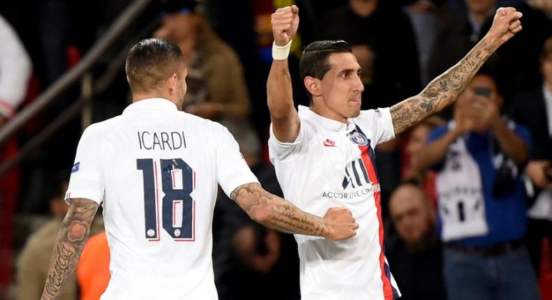 Angel Di Maria celebrates with Mauro Icardi after scoring one of his two goals as Paris Saint-Germain beat Real Madrid 3-0 in their Champions League opener