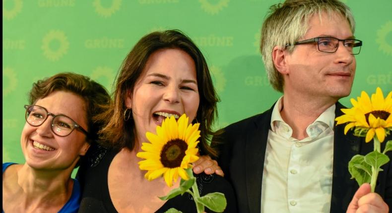 German Green party EU candidate Hannah Neumann (l) celebrates with party co-leader Annalena Baerbock and the Greens top candidate Sven Giegold after the exit poll figures were announced