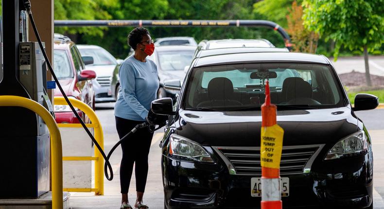 A woman fills her car at a gas station in Annapolis, Maryland, on May 12, 2021. Fears the shutdown of the Colonial Pipeline because of a cyber attack would cause a gasoline shortage led to some panic buying and prompted US regulators to temporarily suspend clean fuel requirements in three eastern states and the nation's capital.
