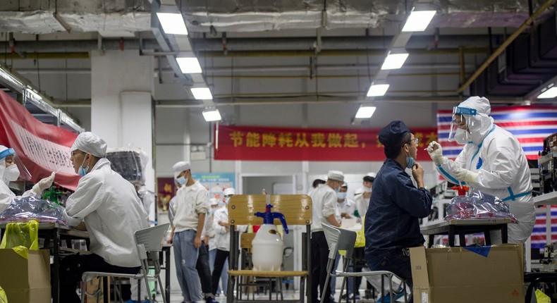 Workers in Foxconn's Wuhan factory in central China get tested for Covid-19 on August 5, 2021.