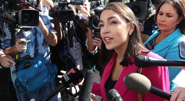 Rep. Alexandria Ocasio-Cortez talks to reporters outside the US Capitol building.