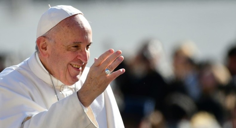 Pope Francis waves to the crowd as he arrives for a weekly general audience at St Peter's square on March 1, 2017 in Vatican