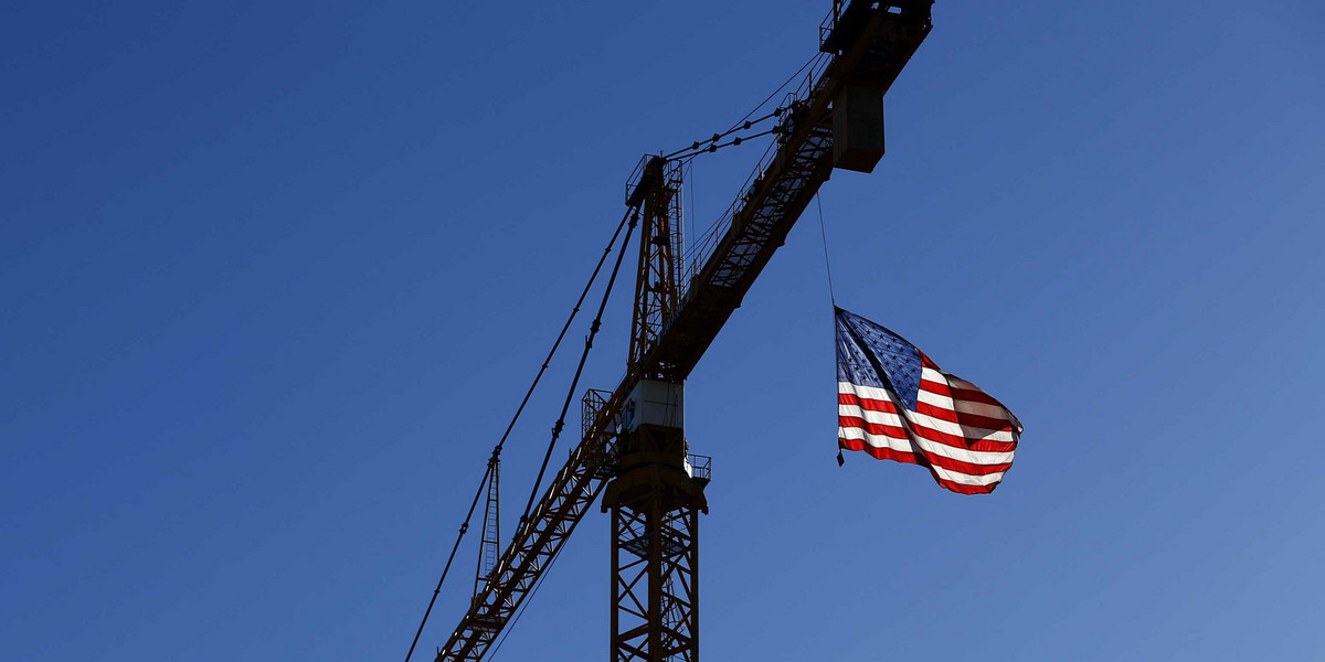 A crane flies an American flag in downtown Los Angeles.