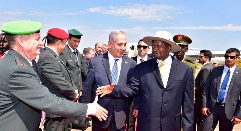 Israeli Prime Minister Benjamin Netanyahu (C) introduces members of his delegation to Uganda's President Yoweri Museveni after arriving to commemorate the 40th anniversary of Operation Entebbe at the Entebbe airport in Uganda, July 4, 2016. 
