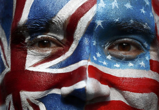 A campaigner with a face-painting poses outside a 'Stop Trump' open-top double decker bus before tou