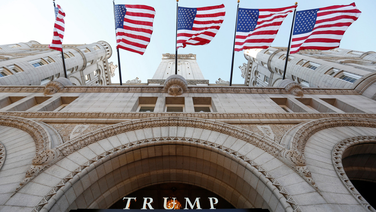 Flags fly above the entrance to the new Trump International Hotel on it's opening day in Washington