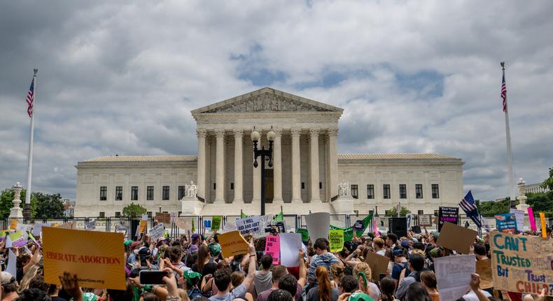 Pro-life and abortion-rights advocates crowd the Supreme Court building after Roe v. Wade was overturned Friday morning.
