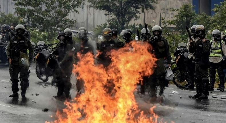 The Venezuelan National Guard stands guard as they clash with opposition activists clash in Caracas on April 13, 2017