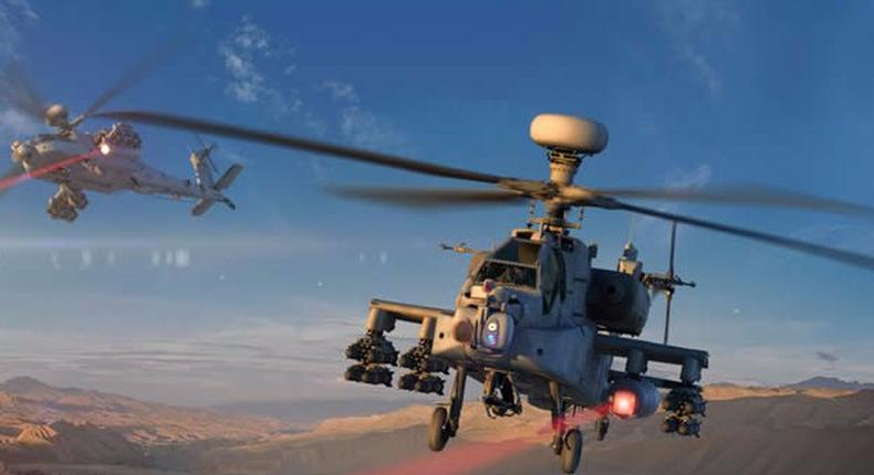 An Apache helicopter firing a laser weapon.