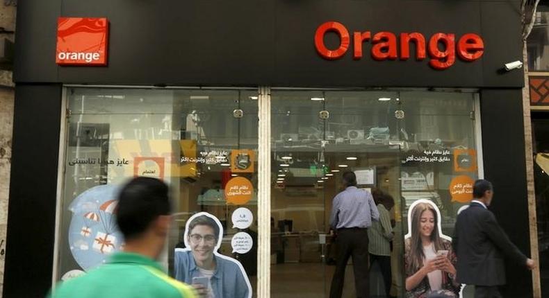 People walk past a new shop of French telecom operator Orange, which was previously known as Mobinil, in Cairo, Egypt, April 6, 2016. REUTERS/Amr Abdallah Dalsh