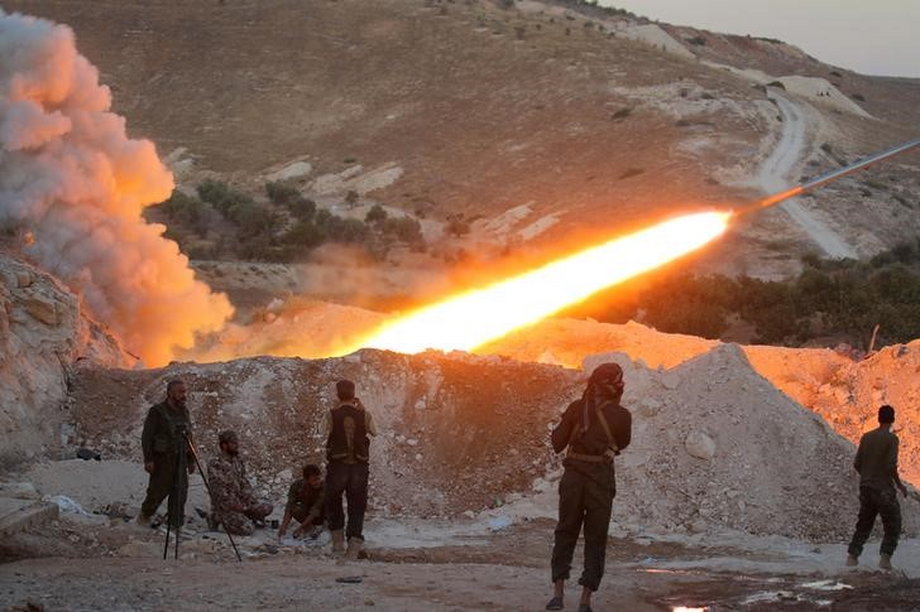 Free Syrian Army fighters launch a rocket from a town toward forces loyal to Syria's President Bashar Assad.
