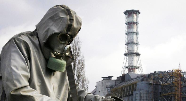 Chernobyl, UKRAINE: A rescue worker sets flag signalling radioactivity in front of Chernobyl nuclear power plant during a drill organized by Ukraine's Emergency Ministry 08 November 2006. Employees and rescue workers improved their reactivity in case of a collapse of the sarcophagus covering the destroyed 4th power block.