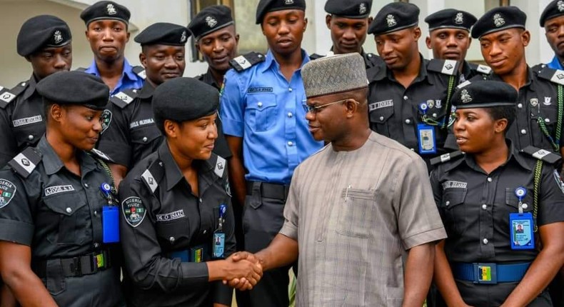 Yahaya Bello greeting police officers.