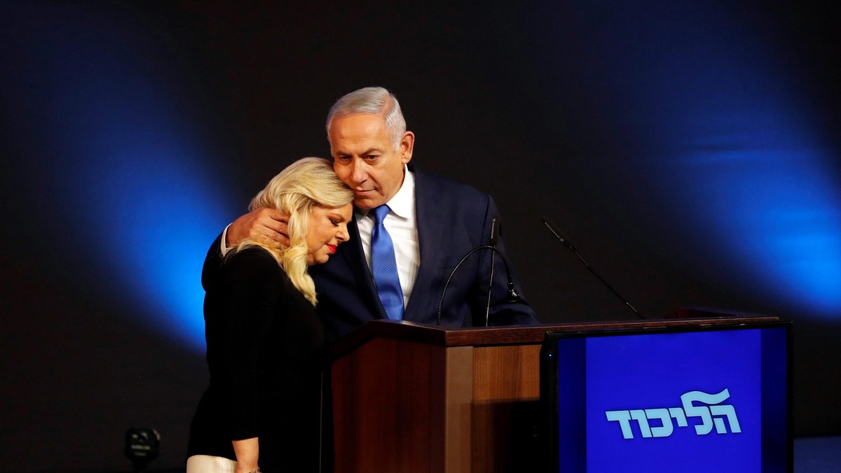 Israeli Prime Minister Benjamin Netanyahu hugs his wife Sara as they stand on stage following the an