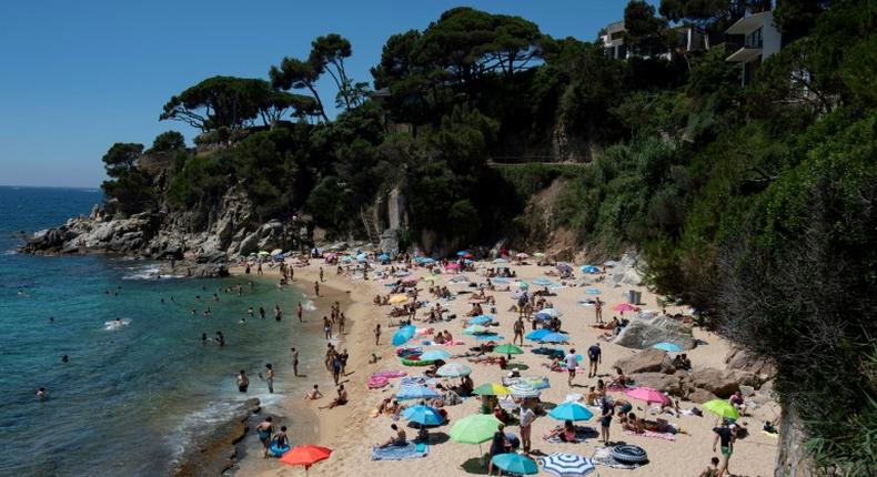 People enjoy a day out at the beach in Platja D'Aro near Girona -- Spaniards endured one of the world's toughest lockdowns for three months from March 2020