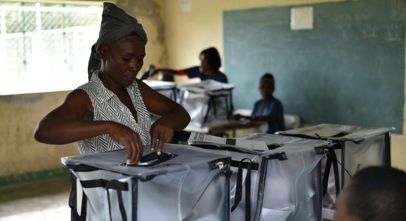 A voter casts her ballot at a polling station in a school in the commune of Cite Soleil, in the Haitian capital Port-au-Prince, on November 20, 2016