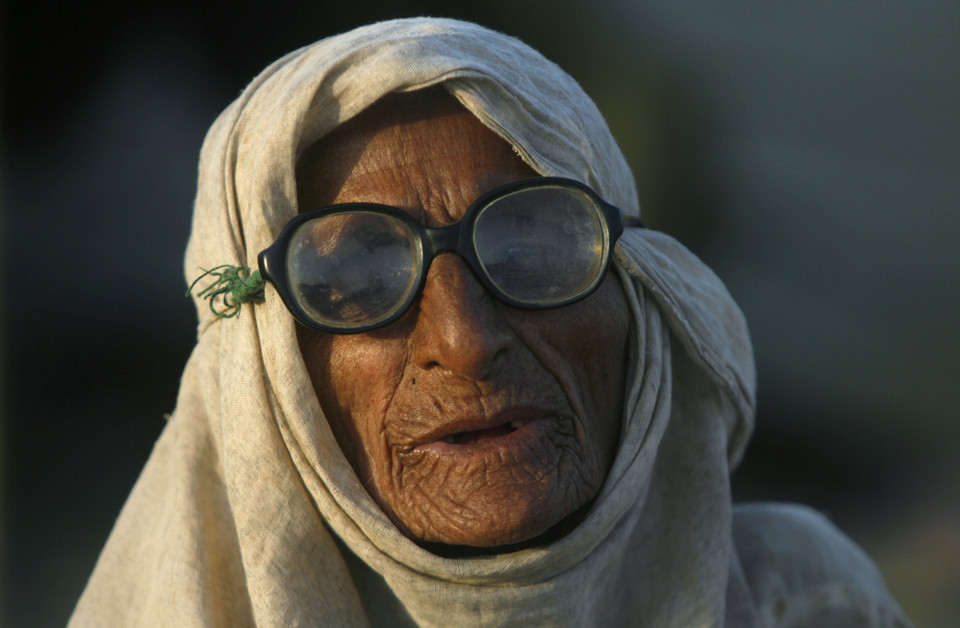 A 91-year-old flood victim sits outside her tent at a flood relief camp set up by the Pakistani army in Sehwansehwan