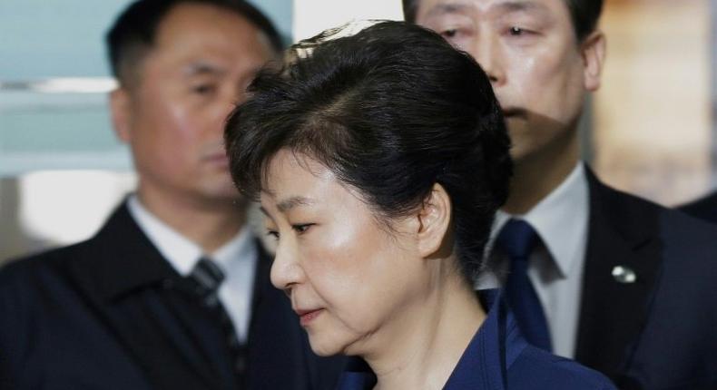 South Korea's ousted president Park Geun-Hye (front) arrives for questioning on her arrest warrant at the Seoul Central District Court in Seoul on March 30, 2017