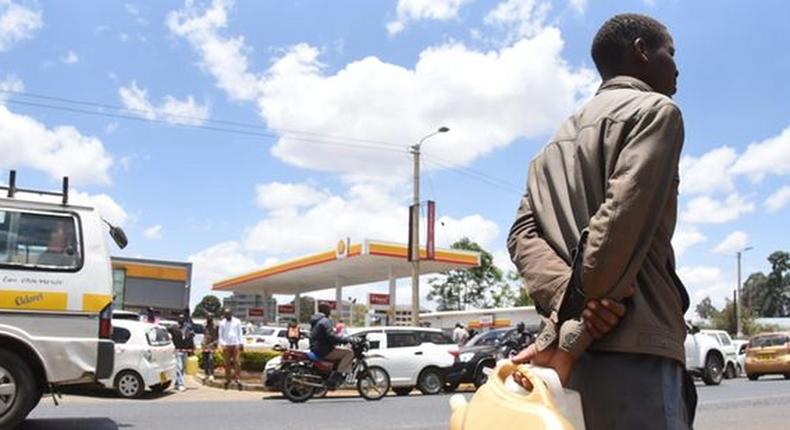A man with jerrycans waits to buy fuel in Eldoret town on April 3, 2022 amid a biting shortage. Jared Naytaya | Nation Media Group