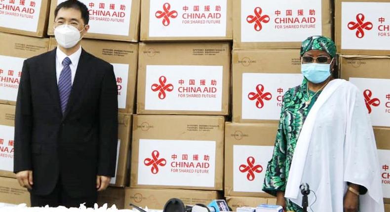 Mr Show Yong, Dep. Amb of the Chinese Embassy in Abuja and Hajiya Hajo Sani, representative of First Lady, Aisha Buhari receiving the equipment. [Twitter/@china_emb_ng]