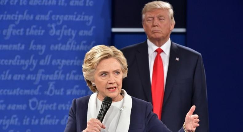 Republican presidential candidate Donald Trump listens to Democratic candidate Hillary Clinton during the second presidential debate in St. Louis, Missouri on October 9, 2016