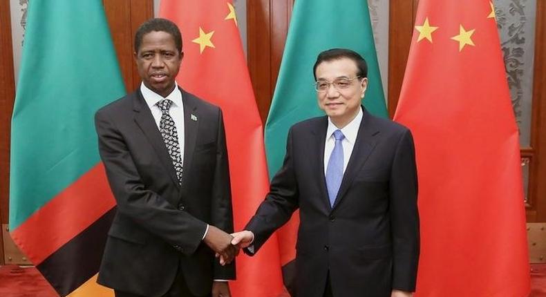 Chinese Premier Li Keqiang (R) shakes hands with Zambia's President Edgar Chagwa Lungu at the Great Hall of the People in Beijing March 30, 2015. REUTERS/Feng Li/Pool