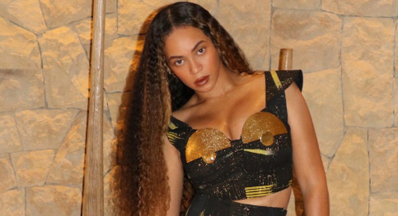 Beyonce wearing a black and gold outfit